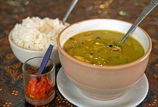 Erwtensoep, green pea soup, a typical Dutch dish, served with rice and sambal in Suriname, Surinam