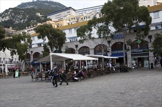 People and cafes in Grand Casemates Square, Gibraltar, British terroritory in southern Europe,