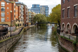 River Kennet flowing past apartment housing in town centre, view east from London Street Reading,