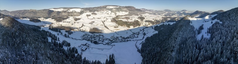 View over Chatzenstaeg, rocky ridge, to Ramiswil and Passwang, Jura Mountain Range in winter, drone