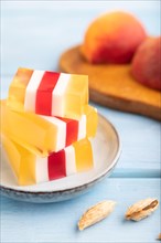 Almond milk and peach jelly on blue wooden background. side view, close up, selective focus