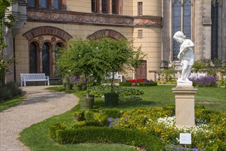 Castle garden with white marble sculpture The Allegory of Water or Boy with Shell Horn by Christian