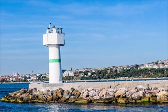 White lighthouse on concrete pier in Bosporus Strait in Istanbul Turkey