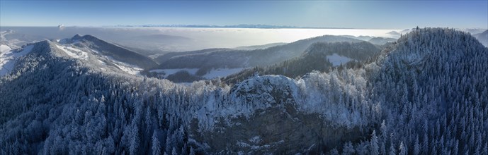 View over the first Jura chain with Belchenflueh in winter into the Central Plateau with high fog,