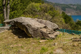 Large ancient boulder in rock garden located in wilderness mountain park in South Korea