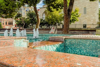 Water fountains in square shallow pool in Istanbul, Turkiye
