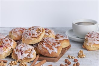 Inviting breakfast with cinnamon buns and a cup of coffee on a wooden table