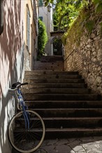 Alley with stairs and bicycle, old town centre of Malcesine, Lake Garda, Province of Verona, Italy,