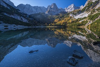 Mountains reflected in mountain lake, sun, autumn, Seebensee, Mieminger Kette, Tyrol, Austria,
