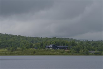 Cabin at Lake Aenevatnet in the rain, landscape format, inland waters, log cabin, holiday home,