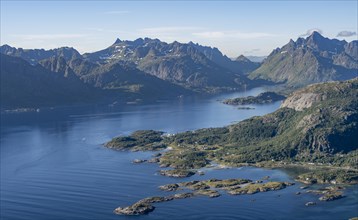 View of coast in Raftsund fjord and mountains in the evening light, view from the top of