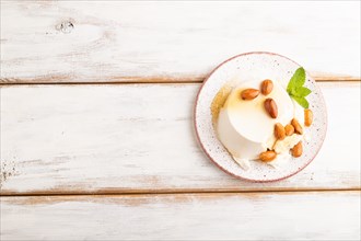 Ricotta cheese with honey and almonds on white wooden background. top view, flat lay, copy space