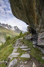 Hiking trail under a rocky outcrop in a picturesque mountain landscape, Berliner Hoehenweg,
