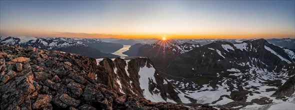 Panorama, view of mountains and fjord Faleidfjorden, sun star at sunset, summit of Skala, Loen,