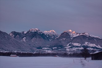 Snowy landscape at sunrise with mountain panorama, view of Wendelstein, Nussdorf, Bavaria, Germany,