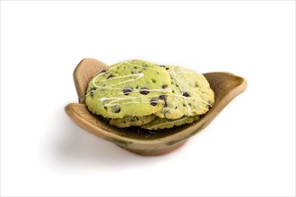 Green cookies with chocolate and mint on leaflike ceramic plate isolated on white background. side