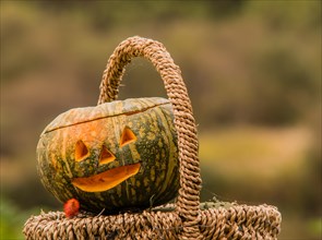Closeup of Jack-O-Lantern in wicker basket with blurred out background in South Korea