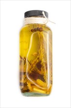 Sunflower oil in a glass jar with various herbs and spices, lavender, sesame, rosemary isolated on