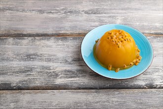 Mango and passion fruit jelly on gray wooden background. side view, copy space