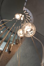 Modern Illuminated Hanging Lamp in Concrete Spiral Staircase with Railing in Switzerland