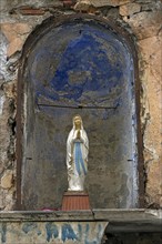 Figure of the Virgin Mary in a niche in a wall of an empty temple, 15th century, historic centre,