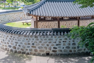 Old mud and stone jailhouse with tiled roof located in historic park in South Korea