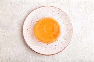 Papaya and orange jelly on gray concrete background. top view, flat lay, close up