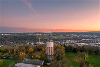Tower in the foreground with a view of the landscape at sunset and a pink sky, Pforzheim, Germany,