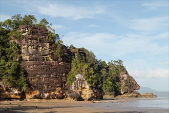Cliff in Bako national park, sunny day, blue sky and sea. Vacation, travel, tropics concept, no