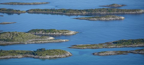 Rocky islands in the blue sea, sea with archipelago islands, Ulvagsundet, Vesteralen, Norway,