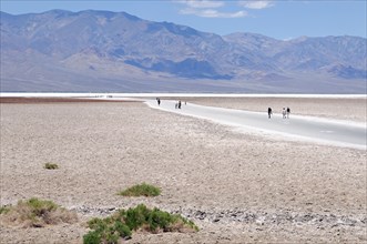 Tourists at the lowest point in the USA, Badwater Point, Death Valley National Park, California,
