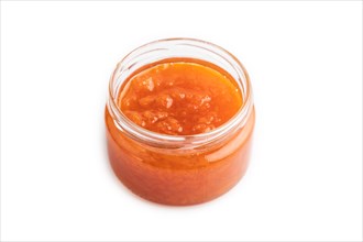 Carrot jam with cinnamon in glass jar isolated on white background. Side view, close up
