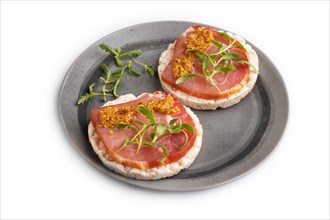 Puffed rice cake sandwiches with jerky salted meat, microgreen and mustard isolated on white