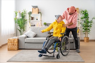 Disabled man and friend looking at each other in the living room at home