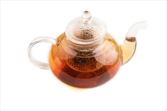 Red tea with herbs in glass teapot isolated on white background. Healthy drink concept. Side view,