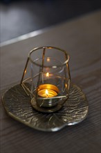 Burning tea light in a candle jar.jpg