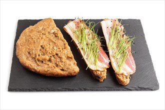Bread sandwiches with jerky salted meat and lard with onion microgreen isolated on white background