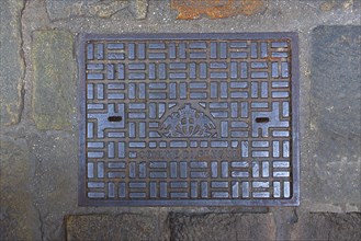Manhole cover with the coat of arms of the city of Genoa, Italy, Europe
