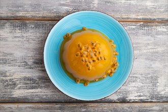 Mango and passion fruit jelly on gray wooden background. top view, flat lay, close up