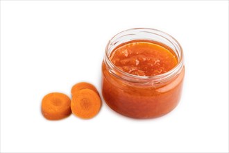 Carrot jam with cinnamon in glass jar isolated on white background. Side view, close up