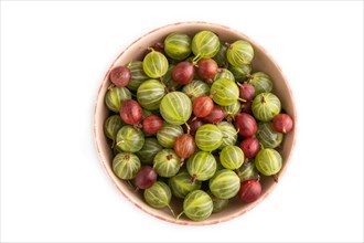 Fresh red and green gooseberry in ceramic bowl isolated on white background. top view, flat lay