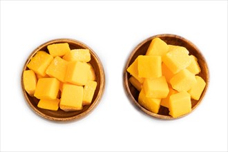 Dried and candied mango cubes in wooden bowls isolated on white background. Top view, flat lay,