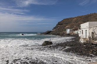 Puertito de los Molinos, beach, waves, several small white houses, west coast, Fuerteventura,