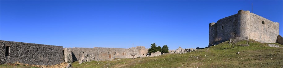 Panoramic picture, Panoramic view of a historic fortress with long walls under a vast blue sky,