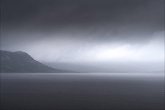 Uncomfortable atmosphere at lake Soenstevatn, landscape format, light mood, thunderstorm, rain,