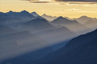 Silhouette of a mountain peak in the evening light, haze, backlight, Ammergau Alps, Upper Bavaria,