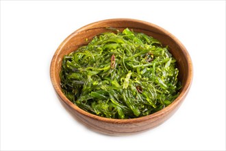 Chuka seaweed salad in brown wooden bowl isolated on white background. Side view