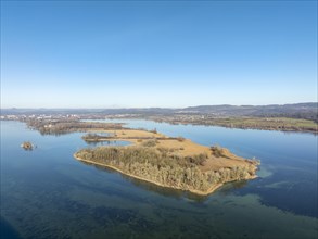 Aerial panorama of the Mettnau peninsula on a clear winter day, on the horizon the town of