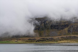 Cloudy mountains, waterfall, Reykjarfjoerour, Strandir, Arnes, Westfjords, Iceland, Europe