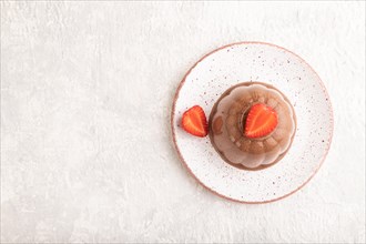 Chocolate jelly with strawberry on gray concrete background. top view, flat lay, copy space
